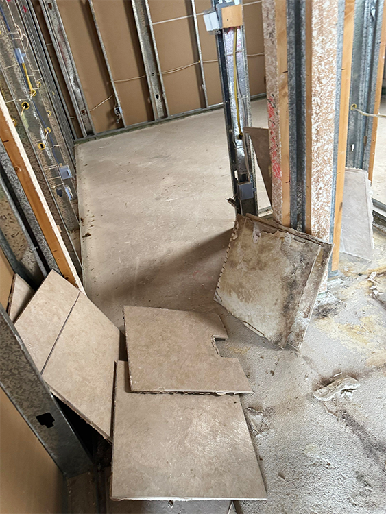 Technician restoring home after fire damage using professional cleaning equipment